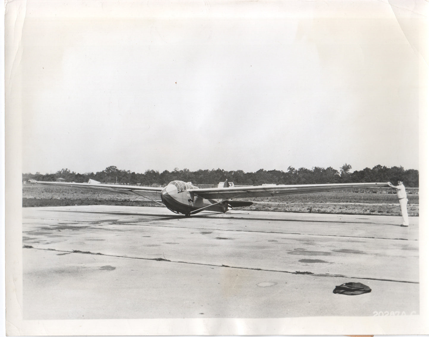 A vintage black and white photograph of a glider aircraft on the tarmac. - Image: Folder17-5