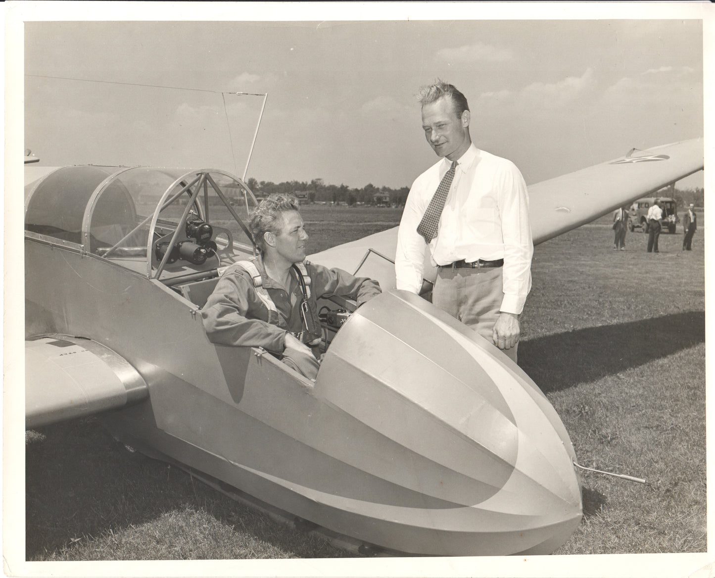 Vintage photograph of two men by a glider aircraft. - Image: Folder20-13
