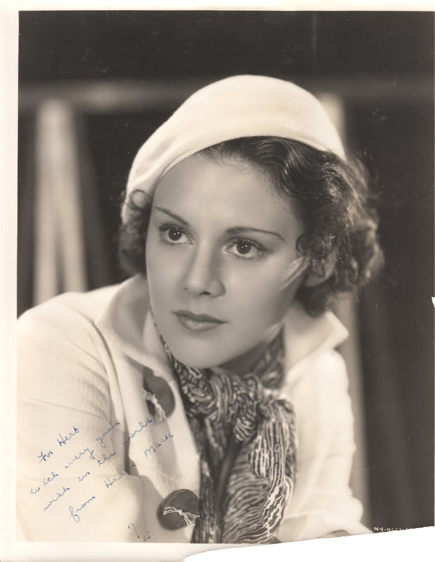 Vintage black and white photograph of a glamorous woman with an autograph.