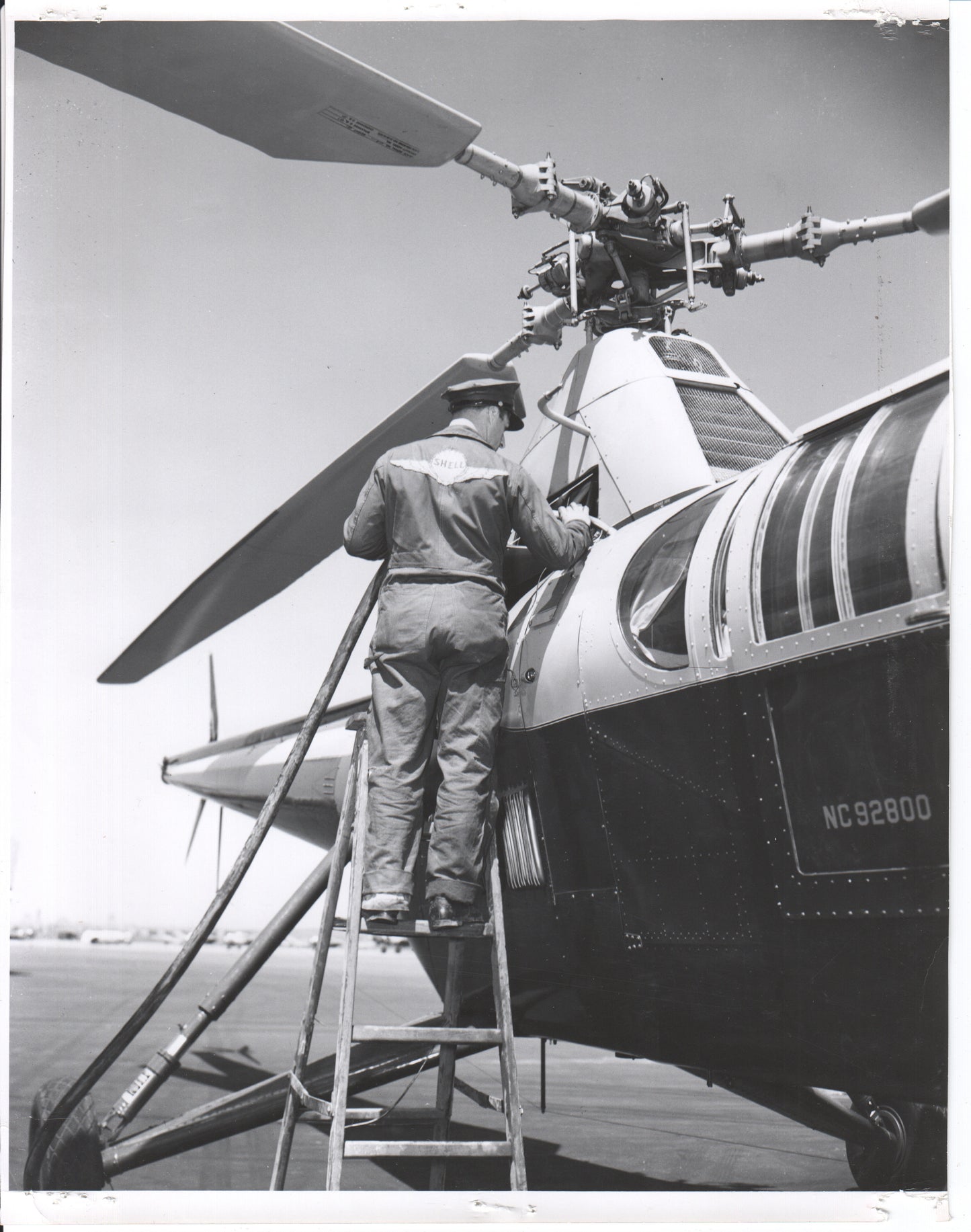 Black and white photo of a technician working on a helicopter - Image: Folder25-9