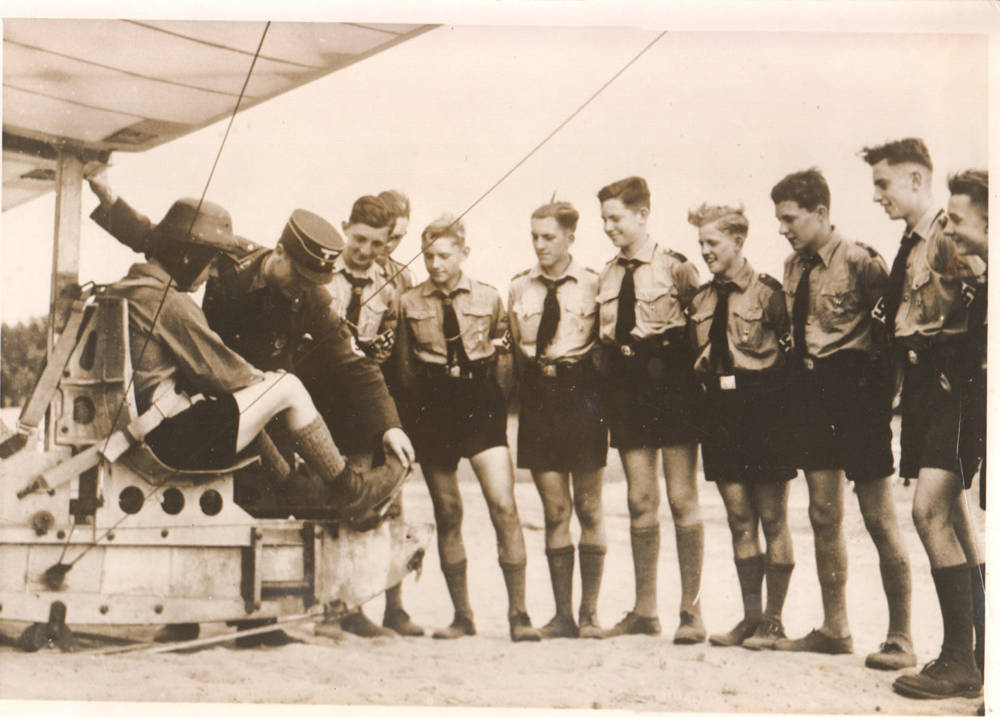 Black and white photograph of boys with a flight instructor near an aircraft. - Image: Folder7-1