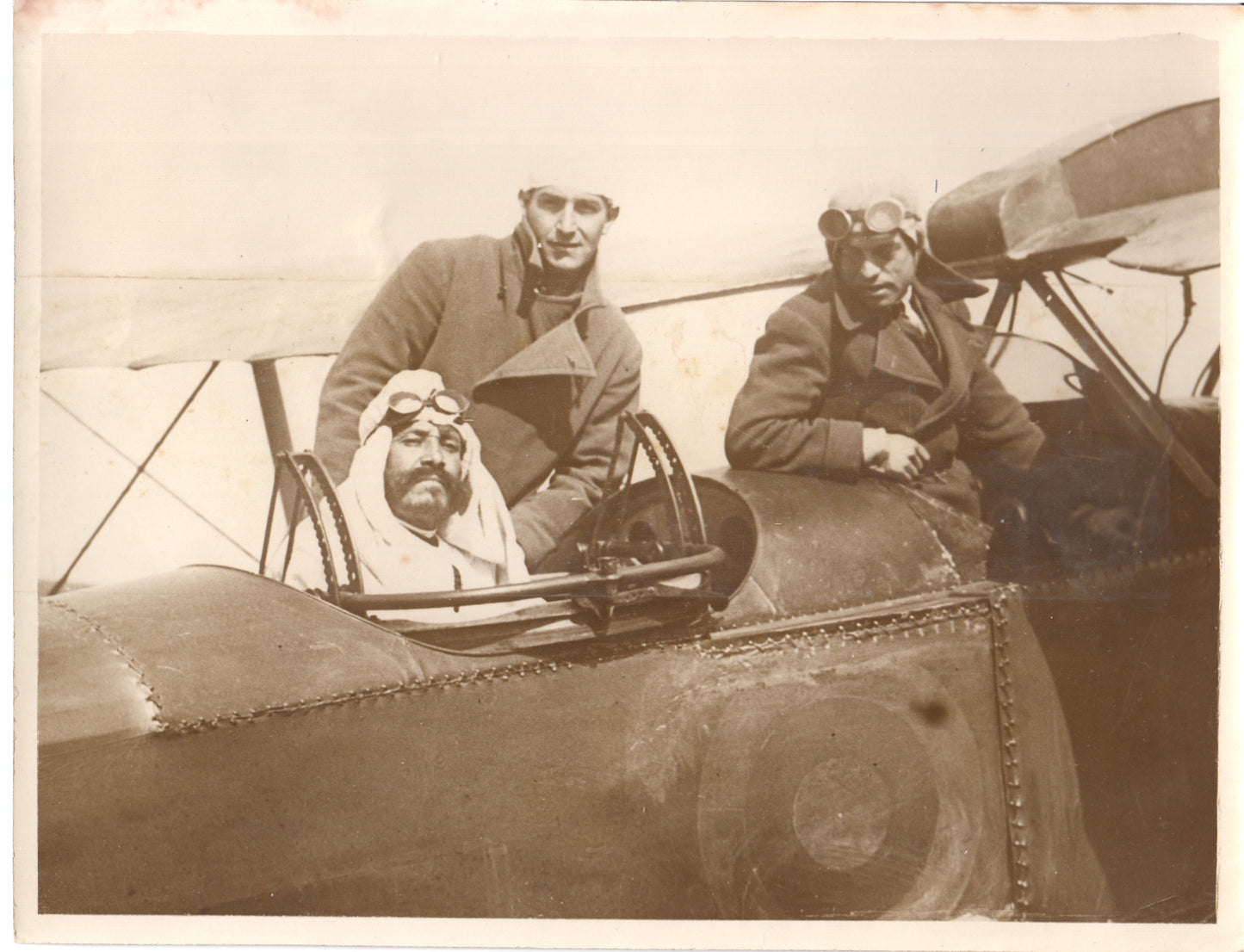 Three aviators in vintage gear next to an early biplane. - Image: Folder27-5