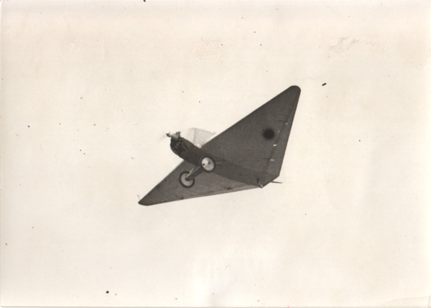 Vintage photograph of a WWII-era military aircraft in flight. - Image: Folder7-13