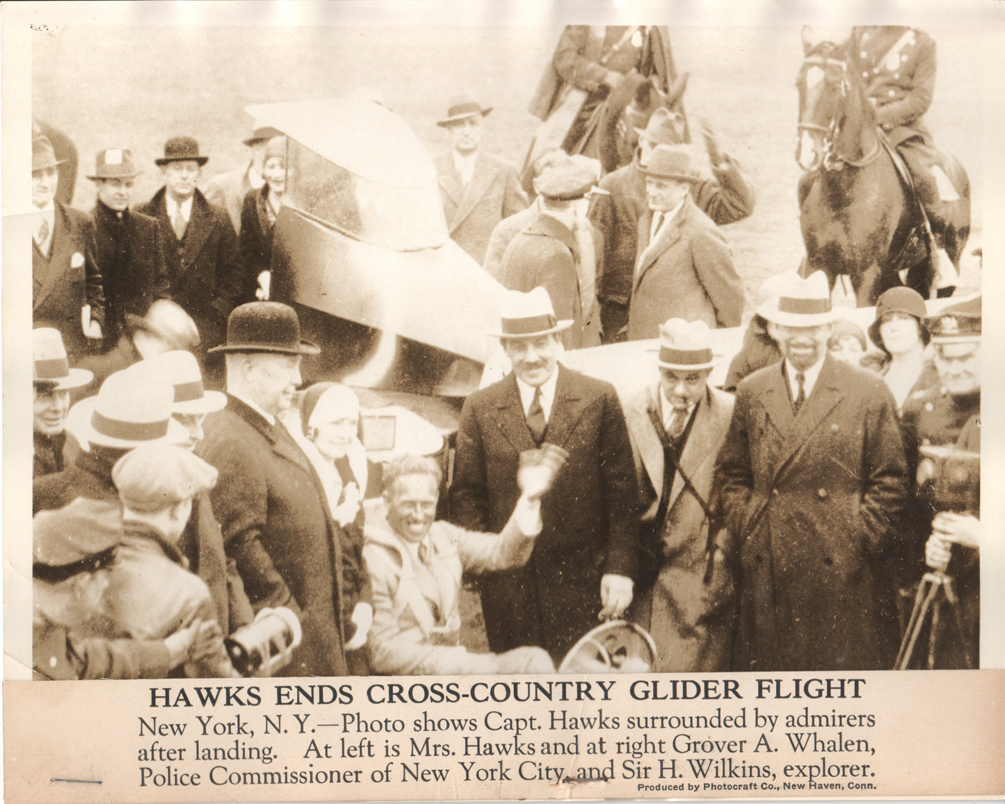 Black and white historic photo of Captain Hawks with admirers after his glider flight. - Image: Folder19-15