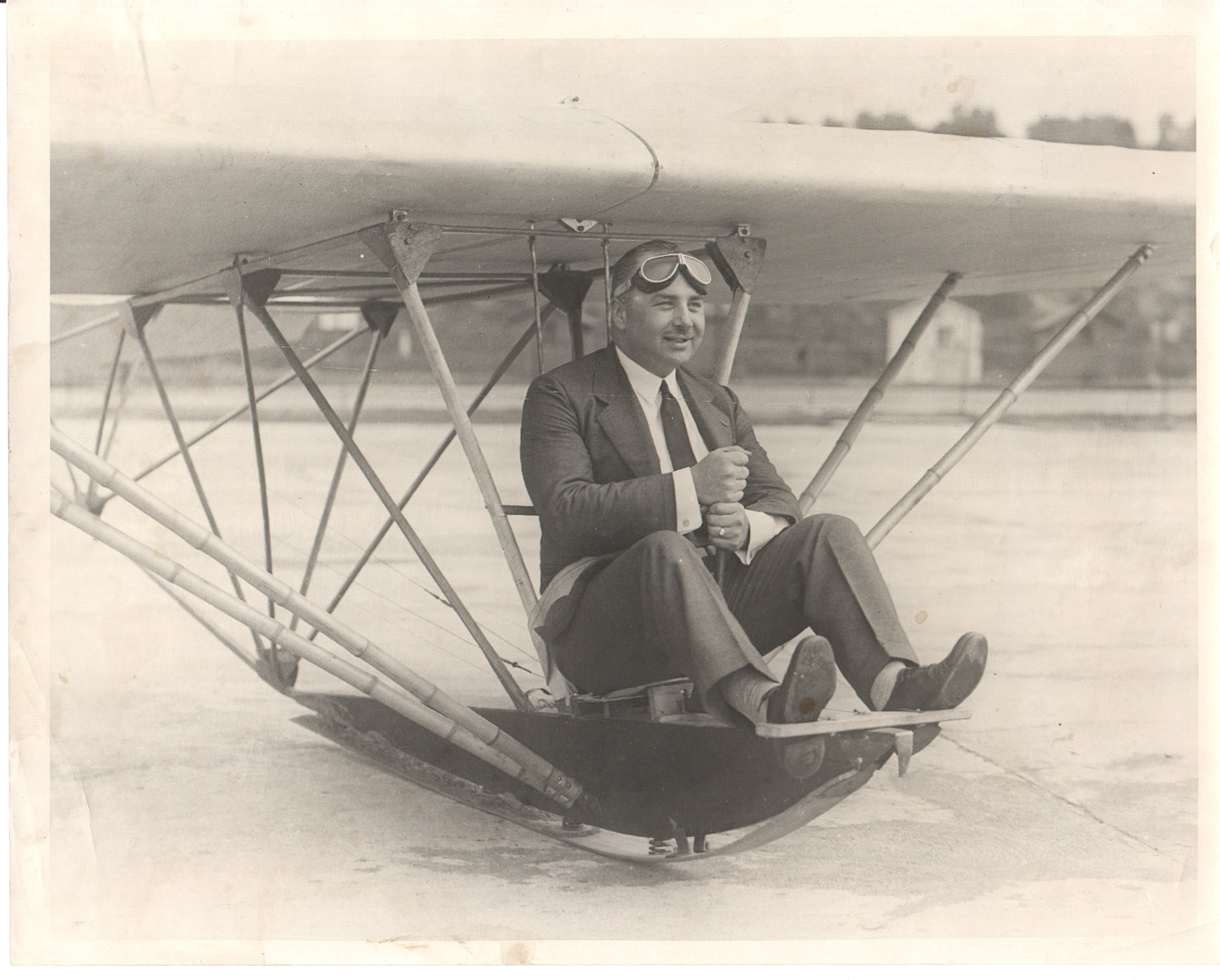 Vintage photograph of a pilot in an early aircraft wearing goggles. - Image: Folder20-15