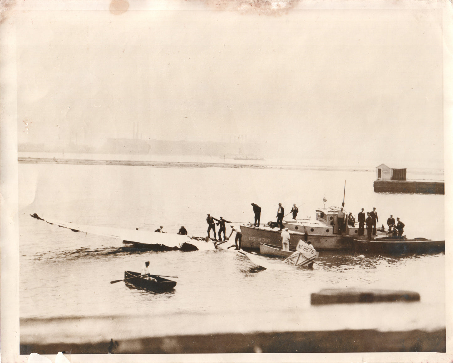 Black and white photograph of a tugboat and crew on a foggy waterway. - Image: Folder25-1