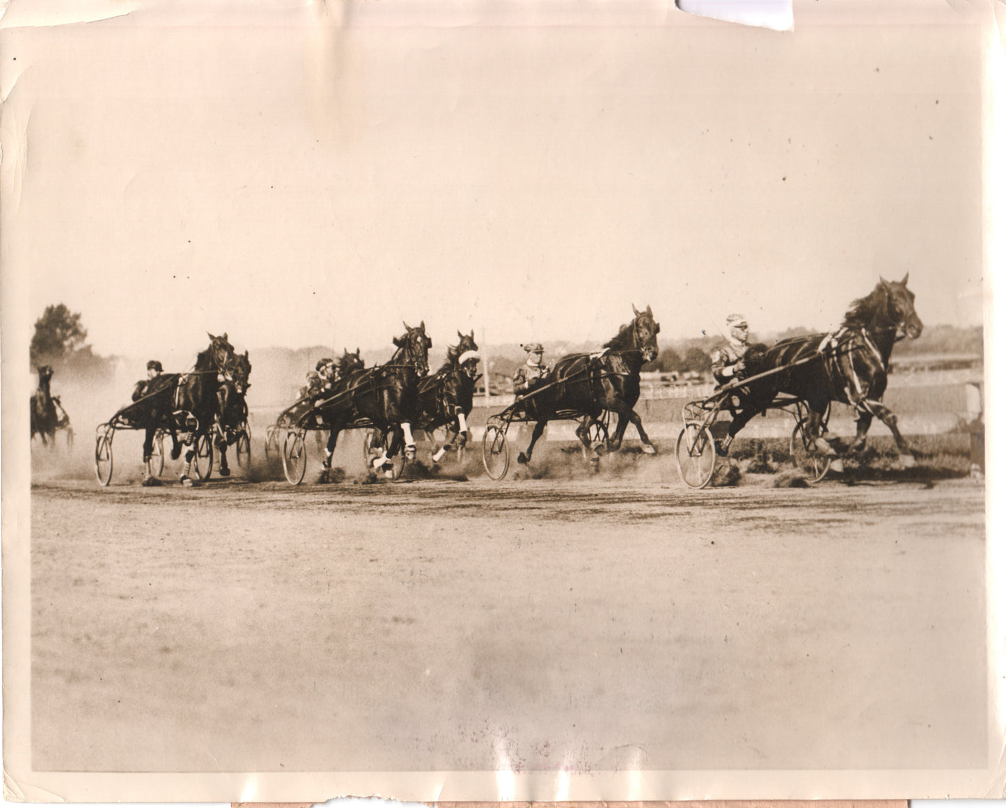 Vintage black and white photo of harness racing horses and jockeys in action. - Image: Folder15-3