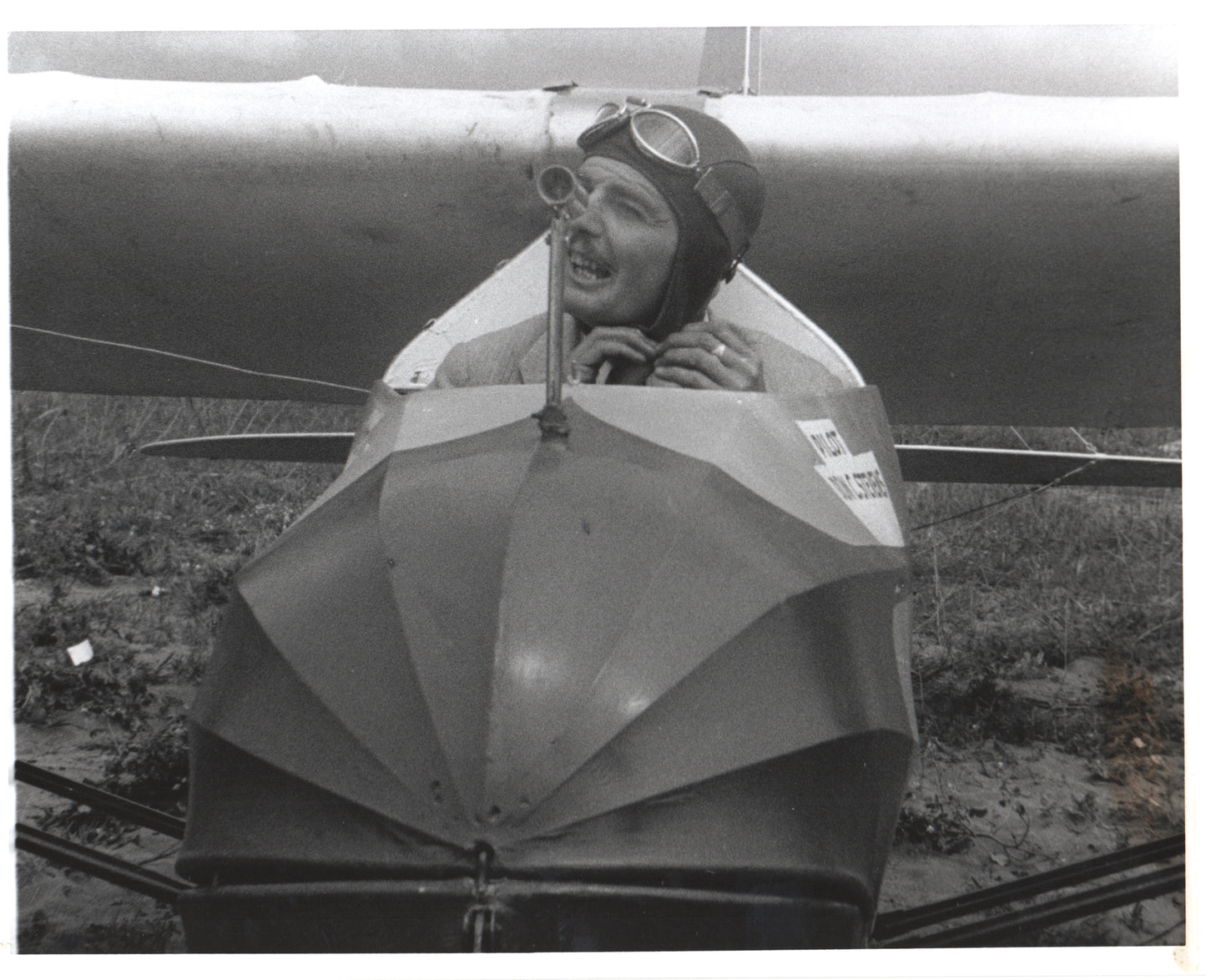 Vintage photograph of a smiling aviator in an antique airplane. - Image: Folder16-11