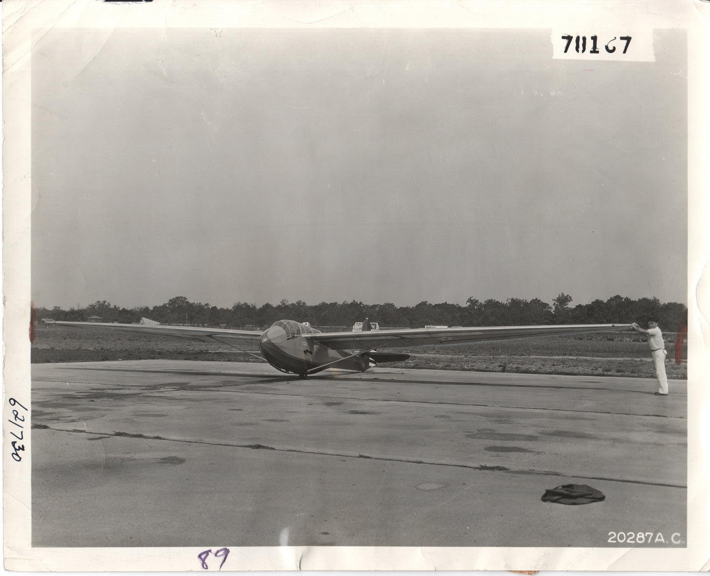Vintage black and white photograph of a sailplane on an airfield. - Image: Folder20-17