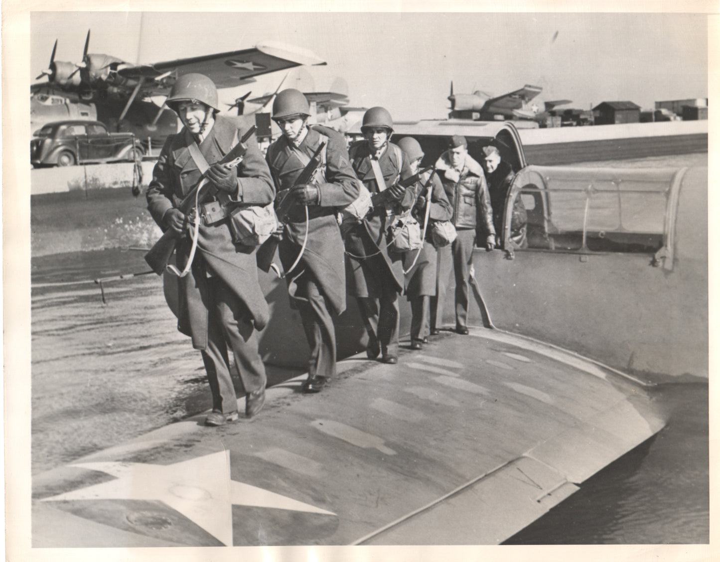 Vintage black and white photograph of soldiers boarding an aircraft during WWII. - Image: Folder17-9