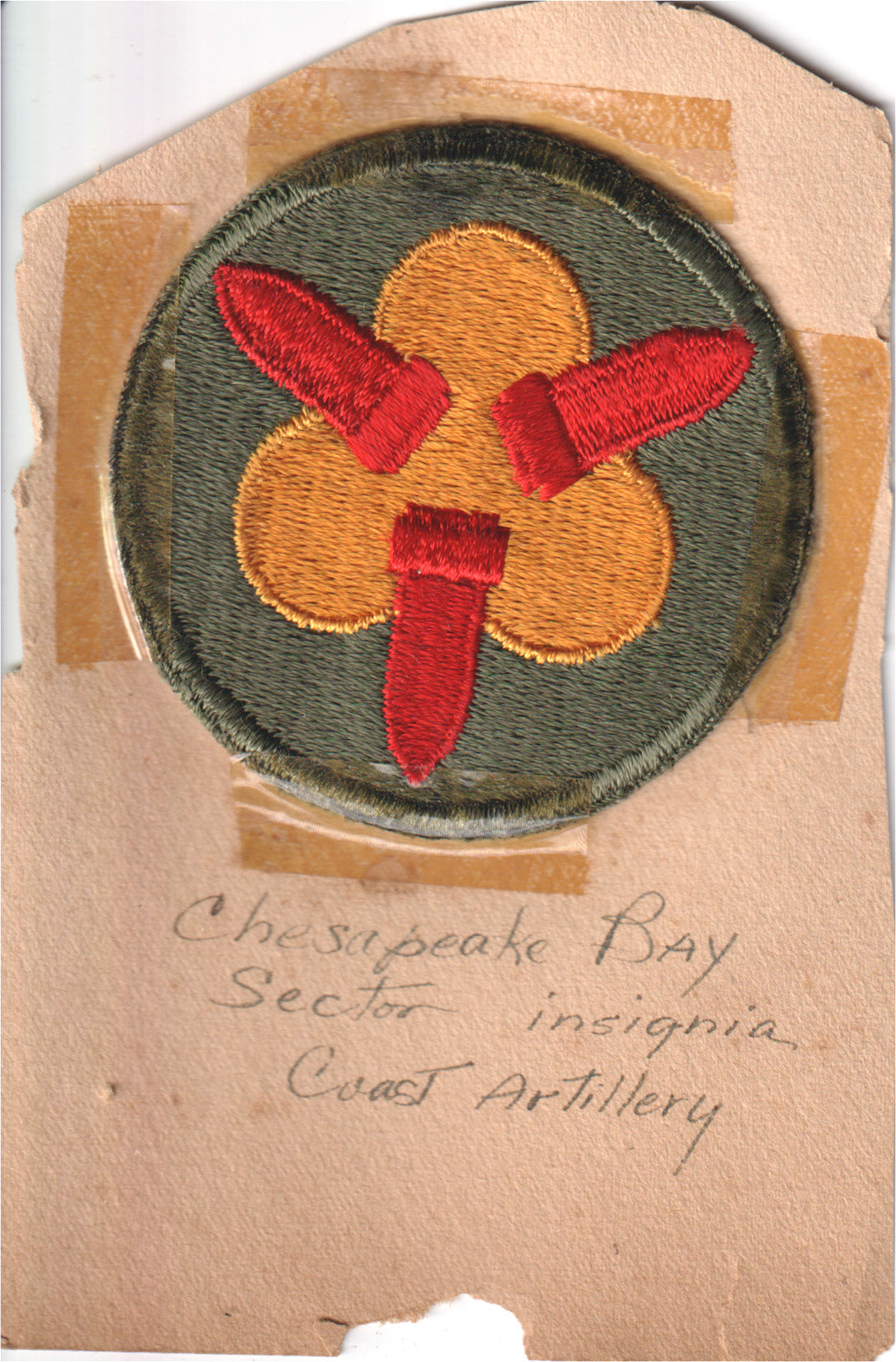 Vintage Coast Artillery insignia patch featuring red and gold embroidery on a green background. - Image: 2025-04-12-0013