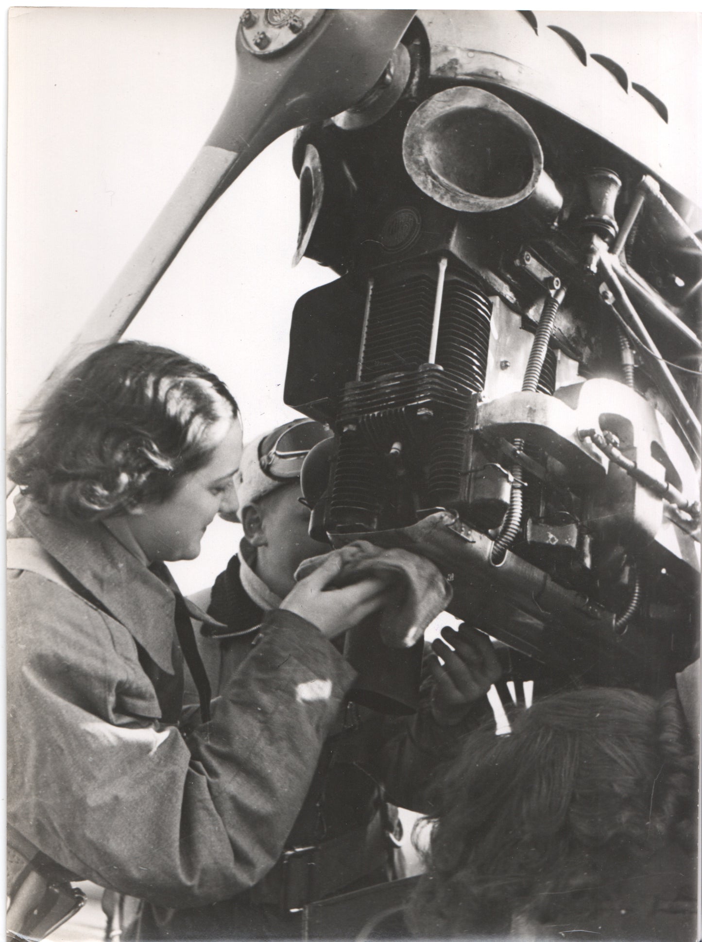 Vintage black and white photo of aviation mechanics working on an aircraft engine. - Image: Folder26-12