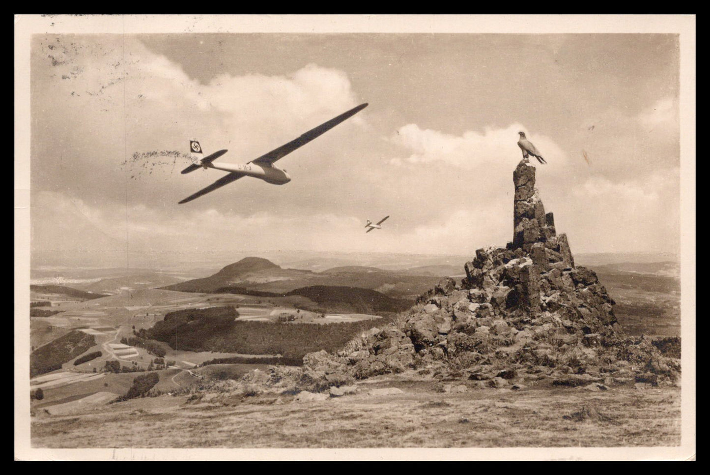 A vintage black and white photo of gliders flying over a mountainous landscape. - Image: MA-PC_0039