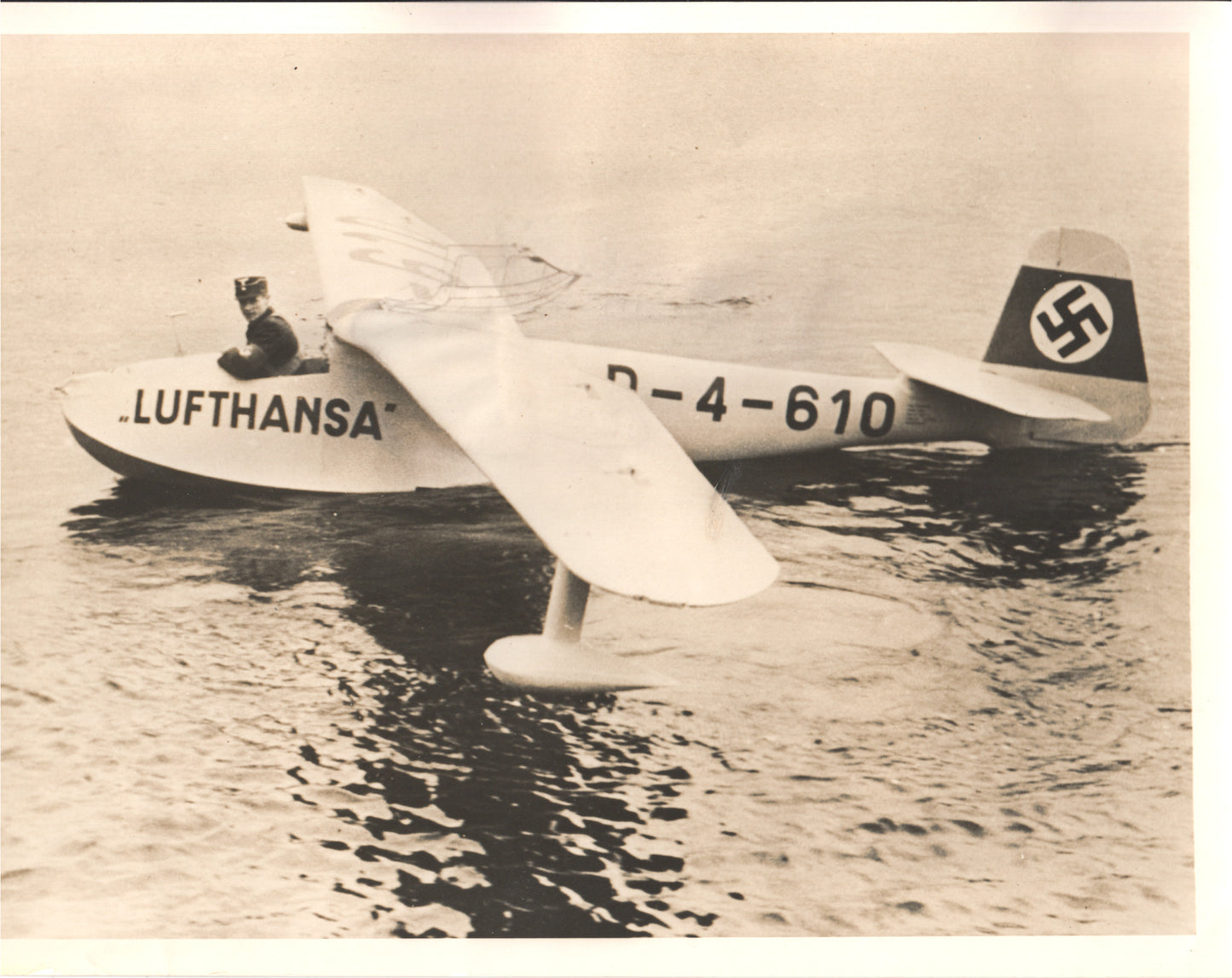 Black and white photo of a WWII-era Lufthansa seaplane on water.