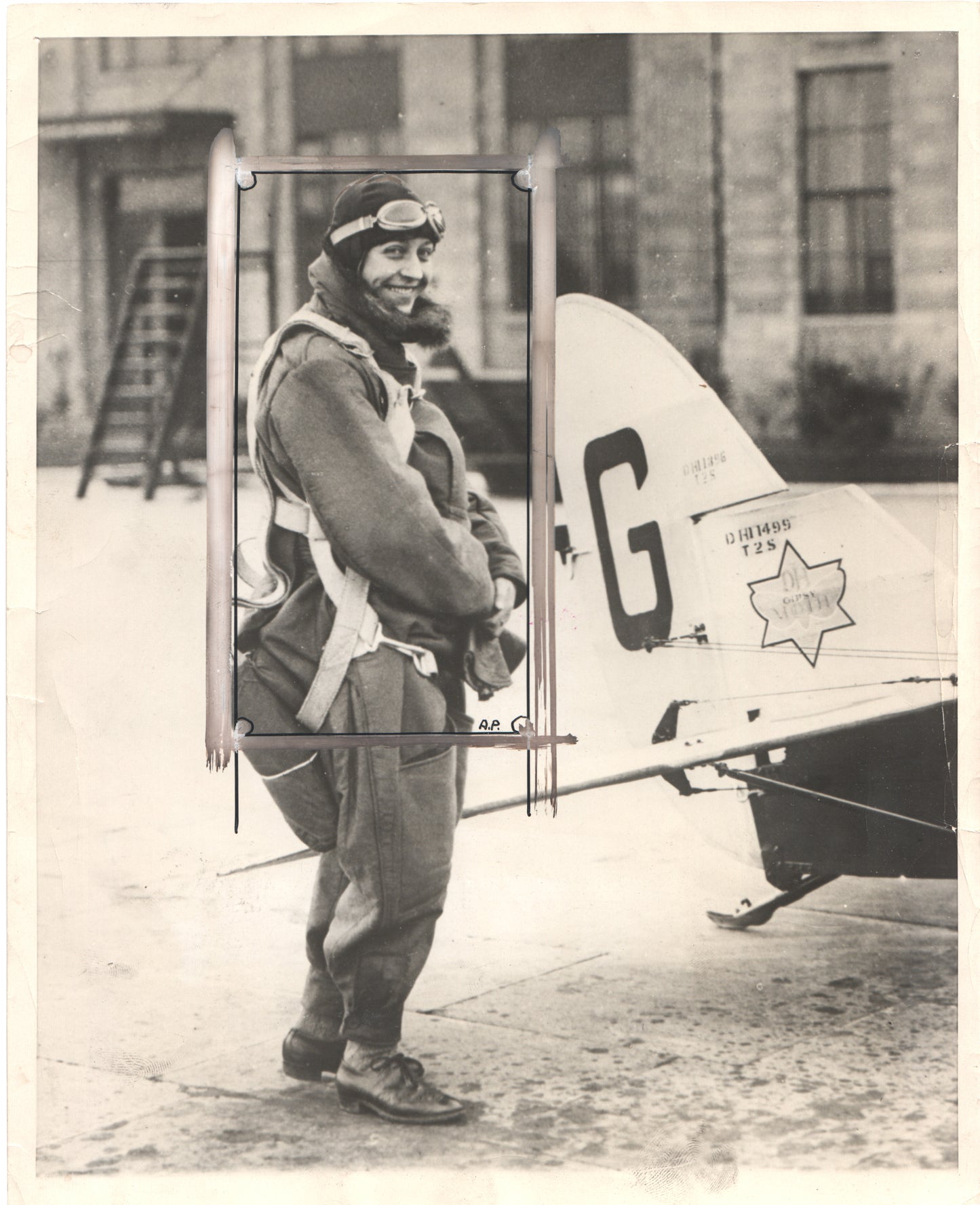 Vintage black and white photograph of a smiling aviator with goggles and flight gear. - Image: Folder16-12