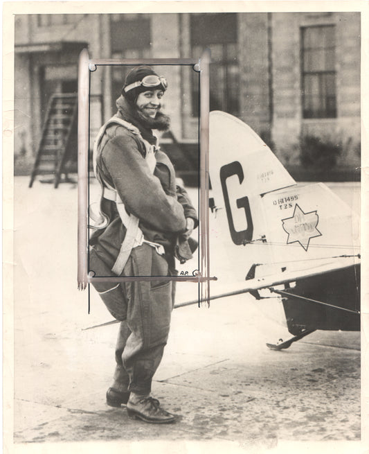 Vintage black and white photograph of a smiling aviator with goggles and flight gear. - Image: Folder16-12