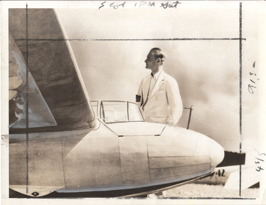 Vintage photograph of a pilot next to an airplane in sepia tones. - Image: Folder10-1
