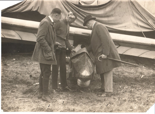Vintage photograph of three men inspecting an early aircraft. - Image: Folder24-1