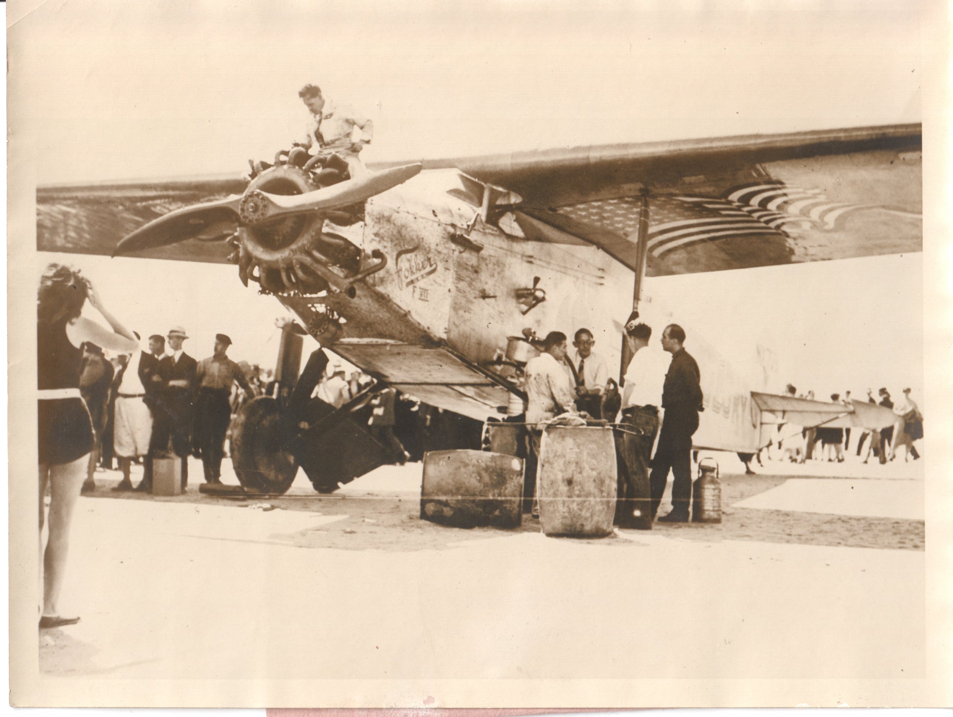 Vintage 1920s photograph of mechanics working on a propeller aircraft. - Image: Folder25-7