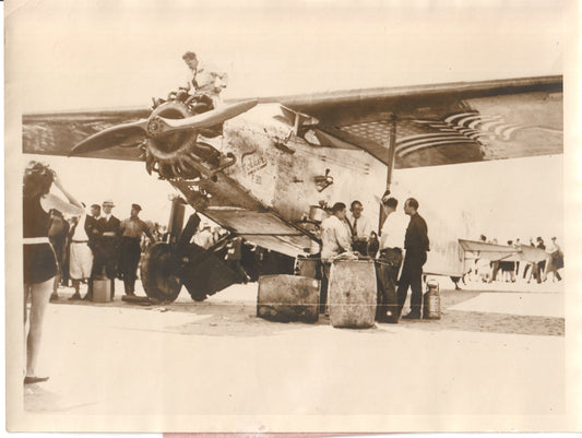 Vintage 1920s photograph of mechanics working on a propeller aircraft. - Image: Folder25-7