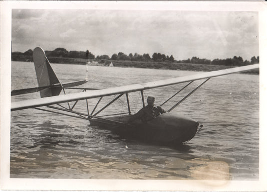 Vintage black and white photograph of a glider on water with a pilot inside. - Image: Folder20-3