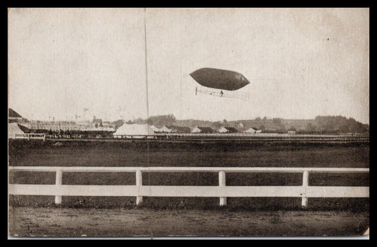Vintage postcard depicting an airship flying over a field. - Image: MA-PC_0041