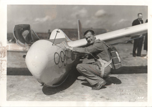 Vintage black and white photograph of a glider pilot with Olympic insignia. - Image: Folder12-5