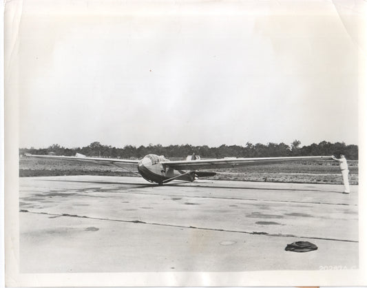 A vintage black and white photograph of a glider aircraft on the tarmac. - Image: Folder17-5