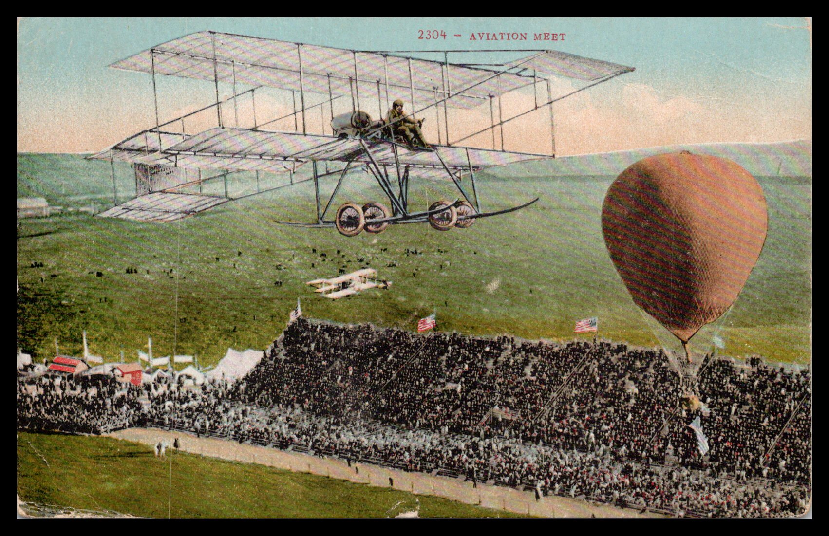 Vintage postcard depicting an aviation meet with an early airplane and hot air balloon over a crowd. - Image: MA-PC_0059
