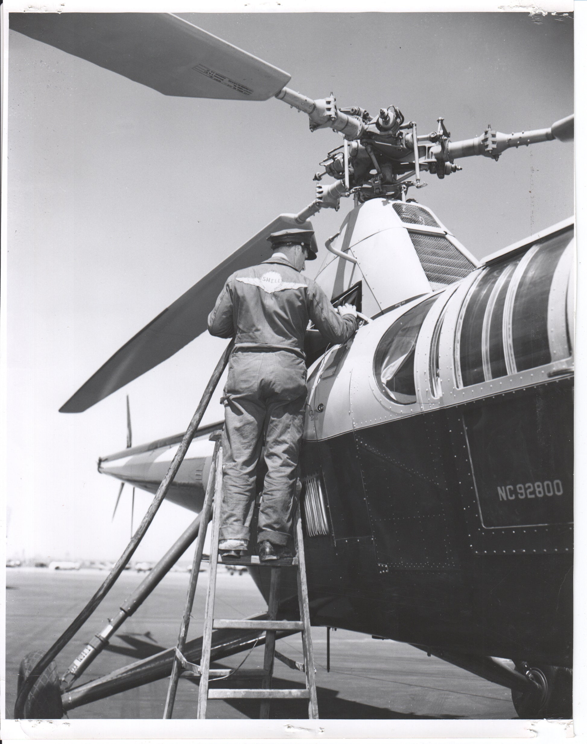 Black and white photo of a technician working on a helicopter - Image: Folder25-9