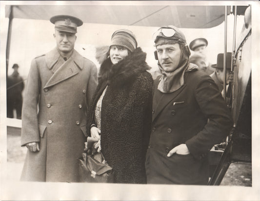 Black-and-white photograph of three individuals in early aviation and military attire. - Image: Folder7-17