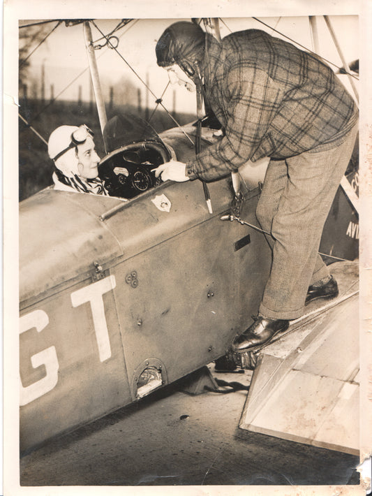 Two pilots in a bi-plane cockpit, captured in a vintage photograph. - Image: Folder24-21