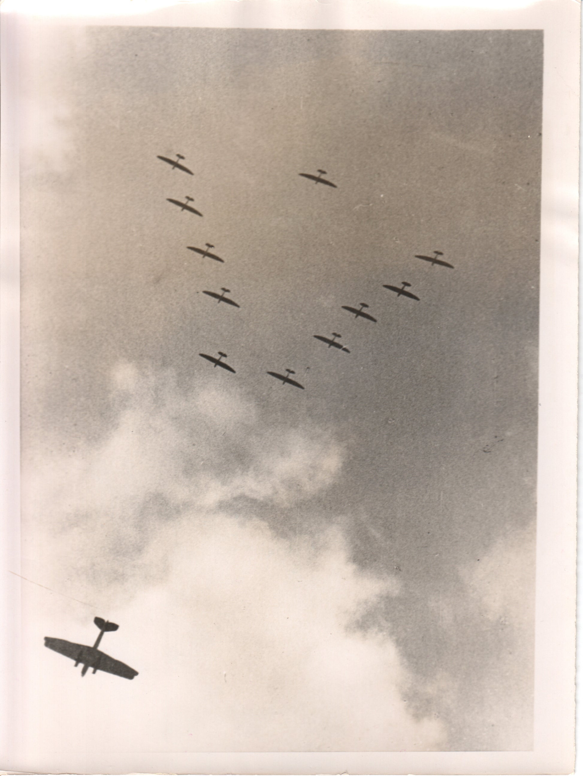 Vintage photograph of aircraft flying in formation against clouds - Image: Folder19-18