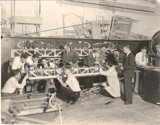 Black-and-white photo of craftsmen working together in a woodworking shop. - Image: Folder21-5