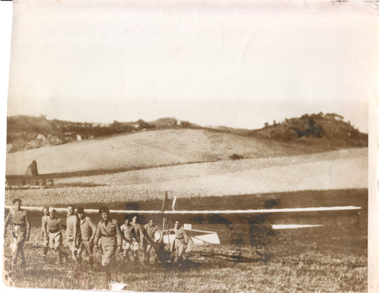 Vintage photograph of aviators with a glider in a grassy field. - Image: Folder27-13