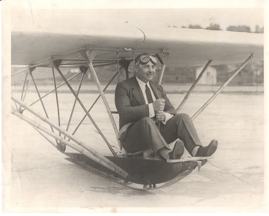 Vintage photograph of a pilot in an early aircraft wearing goggles. - Image: Folder20-15