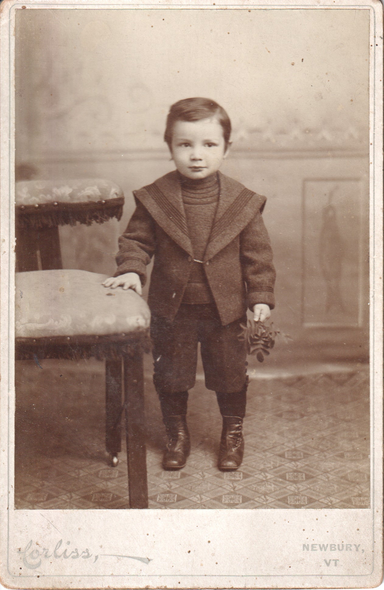 Black and white photo of a young boy in a sailor suit, holding a bouquet. - Image: 2025-04-13-0061