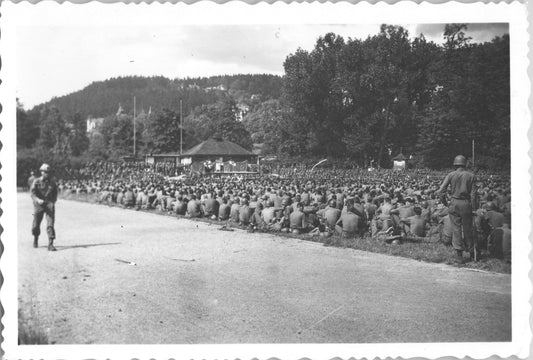 Soldiers seated outdoors in a historical black-and-white photograph. - Image: 2025-08-25-0053