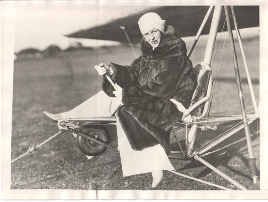 Vintage photo of a woman pilot in a fur coat sitting in a small aircraft. - Image: Folder24-3