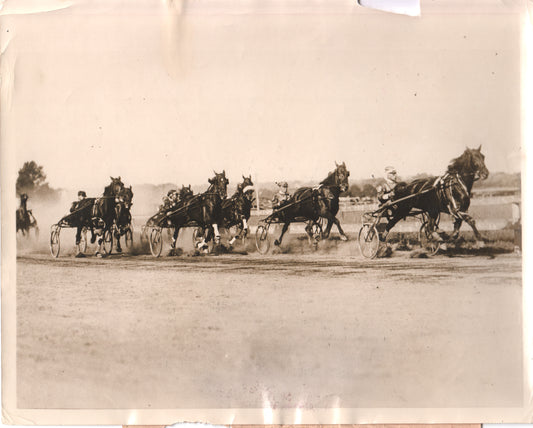 Vintage black and white photo of harness racing horses and jockeys in action. - Image: Folder15-3
