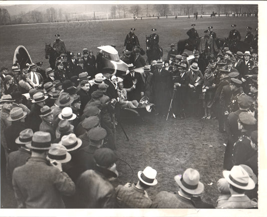 Black and white photo of a crowd gathered around an early airplane at an outdoor event. - Image: Folder3-15
