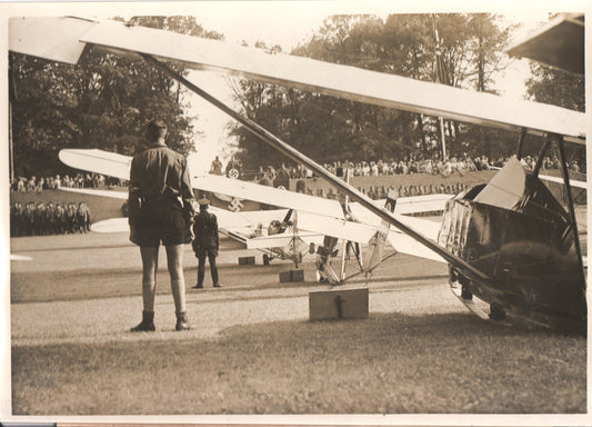 Early 20th-century air show with biplanes and military personnel in uniform. - Image: Folder3-9