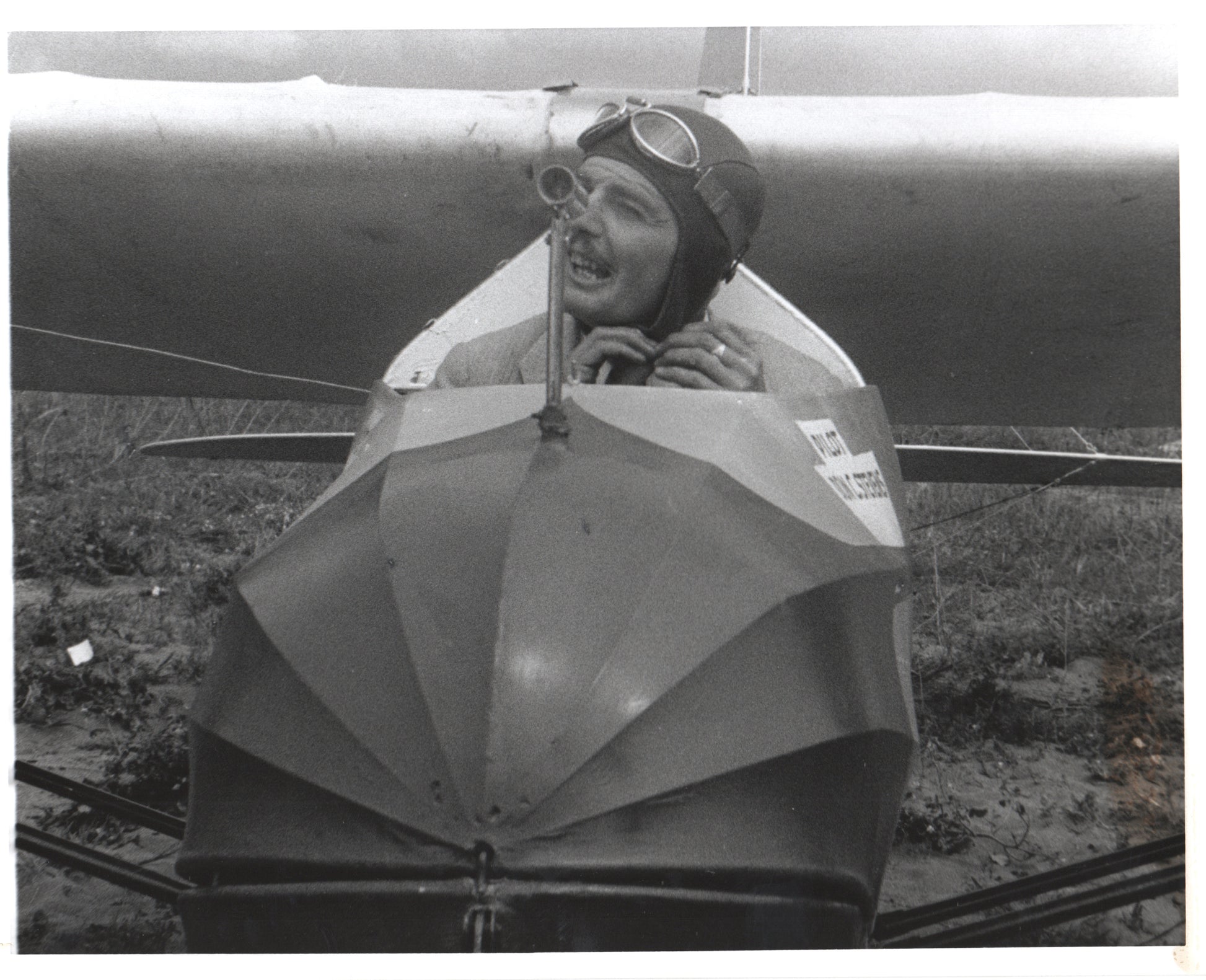 Vintage photograph of a smiling aviator in an antique airplane. - Image: Folder16-11