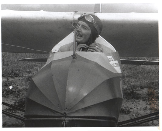 Vintage photograph of a smiling aviator in an antique airplane. - Image: Folder16-11