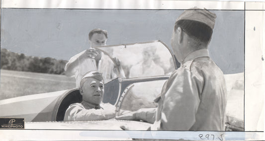 Vintage wirephoto of aviators interacting near a military aircraft. - Image: Folder22-13