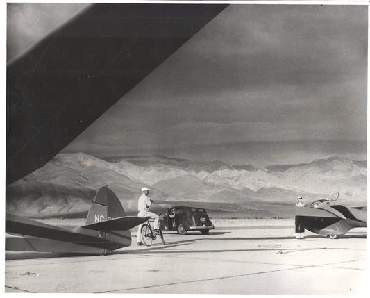 Black and white photo of gliders and a classic car at an airfield. - Image: Folder26-15