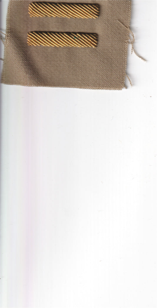 A set of vintage gold-toned metal tie clips on fabric. - File: 2025-05-13-0014.jpg