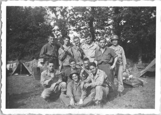Black and white photograph of WWII soldiers posing together in a military camp. - Image: 2025-08-25-0017