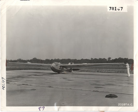 Vintage black and white photograph of a sailplane on an airfield. - Image: Folder20-17