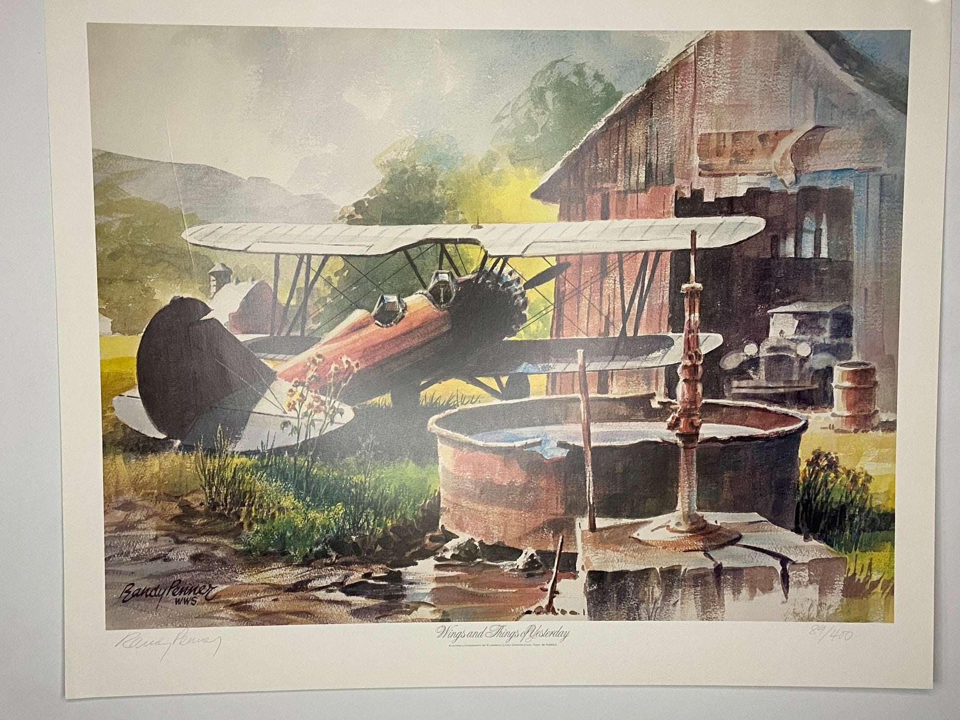 A colorful lithograph of a biplane near a rustic farm. - File: F1IMG_1643.JPG